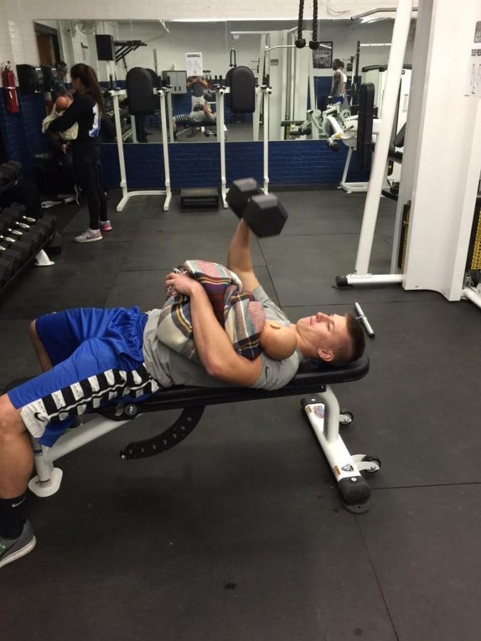 Brandon Parker multitasking with dumbbell and his baby 