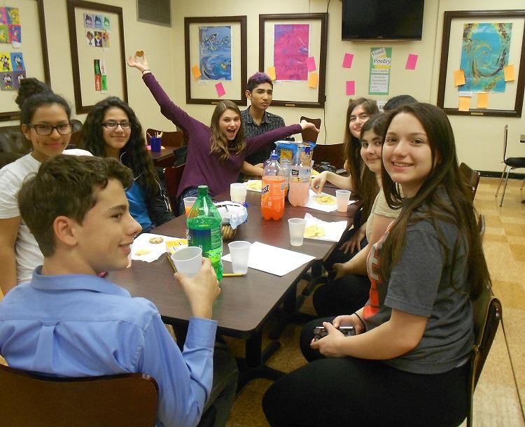 Creative Writing Club members celebrating HHS Poetry Day. Front left to right: Justin Rodrigues, Carina Callegari, Kate Lora, Amanda Kearney, Christian Castillo, Raiya Isaac, Victoria Jungermann, Allie Getchell