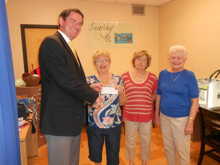 Principal Dan LaGrone accepting a check from HHS Class of 1955 representatives Alice Petkus, Adele Kochan and Betty Knepper. 