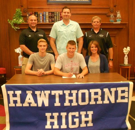 Brandon Parker signing his NCAA Letter of Intent to run track at Sacred Heart University. Standing: Athletic Director Art Mazzacca, Mr. Rob Parker, Coach John LaForge. Seated: brother Ben Parker, Brandon Parker, Mrs. Sue Parker. 