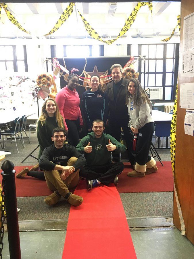 Advanced Media Arts students and Student Council president pose on the red carpet with Media Arts teacher John DiLonardo