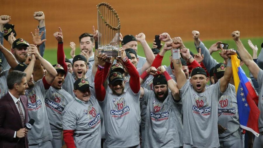 Oct 30, 2019; Houston, TX, USA; Washington Nationals manager Dave Martinez and his team hoist the Commissioners Trophy after defeating the Houston Astros in game seven of the 2019 World Series at Minute Maid Park. The Washington Nationals won the World Series winning four games to three.  Mandatory Credit: Thomas B. Shea-USA TODAY Sports