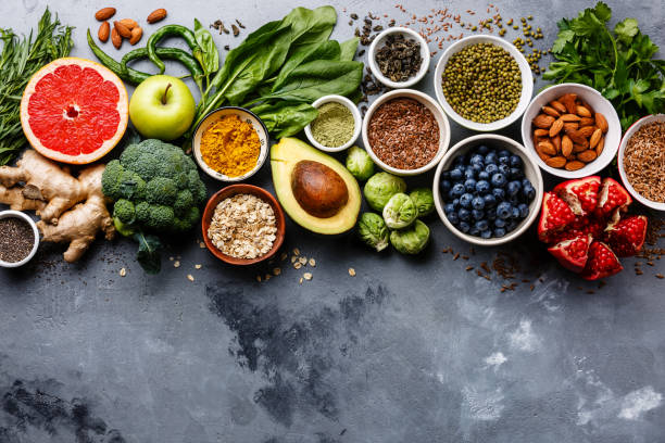 Healthy+food+clean+eating+selection%3A+fruit%2C+vegetable%2C+seeds%2C+superfood%2C+cereals%2C+leaf+vegetable+on+gray+concrete+background+copy+space