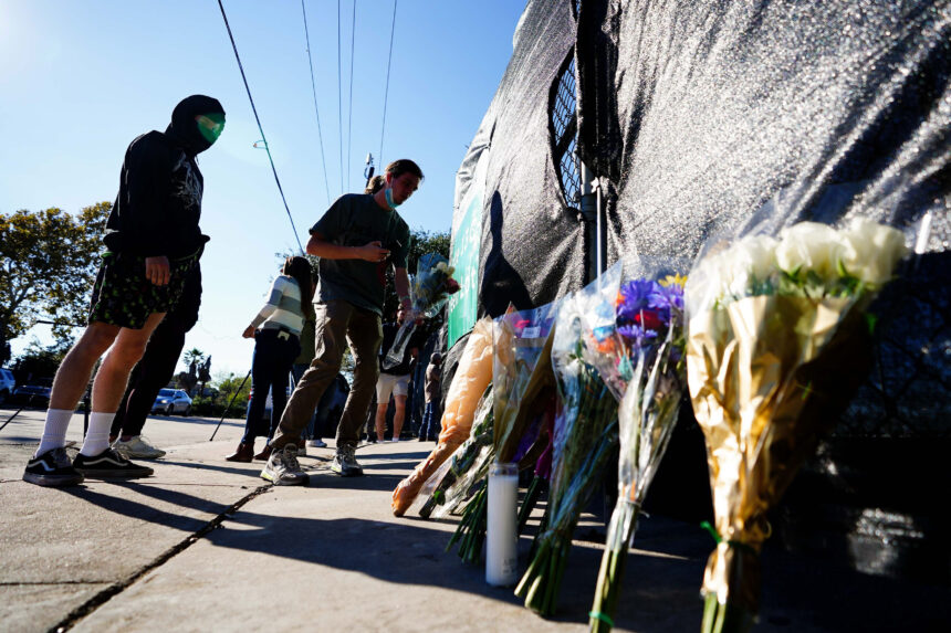 HOUSTON, TX - NOVEMBER 06: A festival patron is seen leading flowers outside of the canceled Astroworld festival at NRG Park on November 6, 2021 in Houston, Texas. According to authorities, eight people died and 17 people were transported to local hospitals after what they describe as a crowd surge at the Astroworld festival, a music festival started by Houston-native rapper and musician Travis Scott in 2018. (Photo by Alex Bierens de Haan/Getty Images)