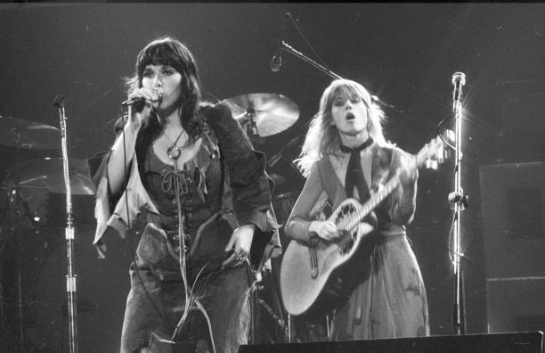 CIRCA 1977:  Ann Wilson and Nancy Wilson of the rock and roll band "Heart" perform onstage in circa 1977.  (Photo by Richard Creamer/Michael Ochs Archives/Getty Images)